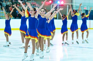 Synchronized skating team finishing a routine at Rocket Ice Skating Rink.