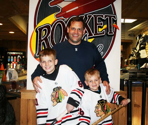 Dad-and-two-sons-after-Hockey-Training-opt2 After a Hockey Training Session at Rocket Ice Skating Rink's Stick and Puck a dad poses with his two sons.