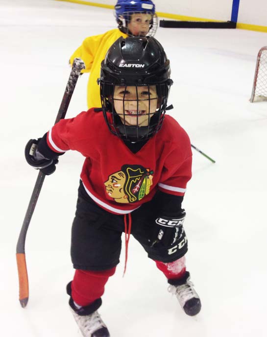Youth at hockey lessons in a red jersey