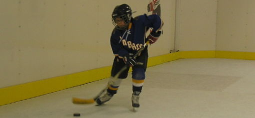 Student training on synthetic ice surface.