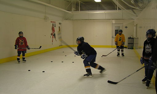 Students training on synthetic ice.