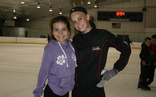 Ice skating rink near Lockport, Rocket Ice - two girls smiling while ice skating.