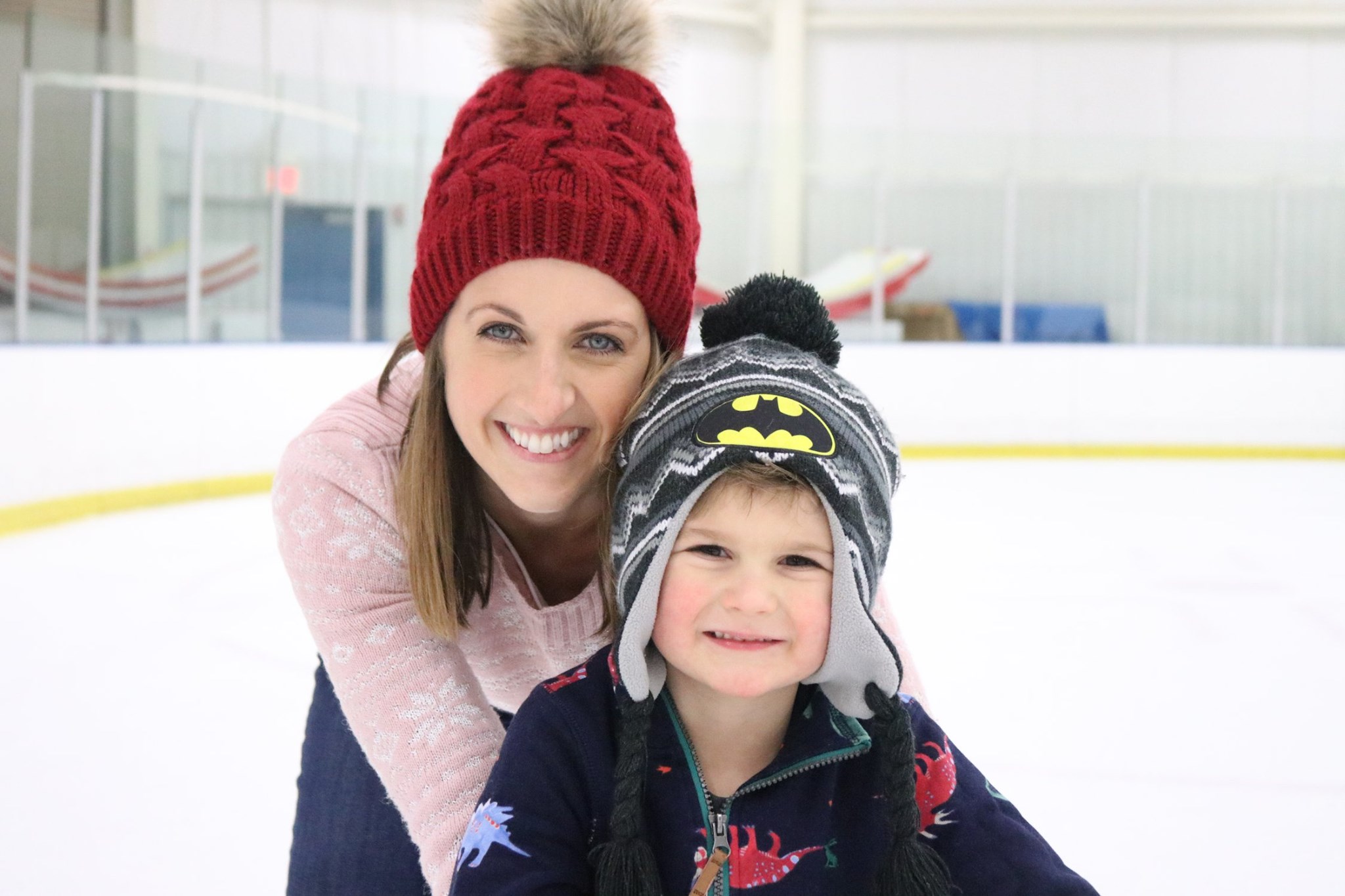 Family acitivity. Mom and son are ice skating at Rocket Ice Skating Rink.