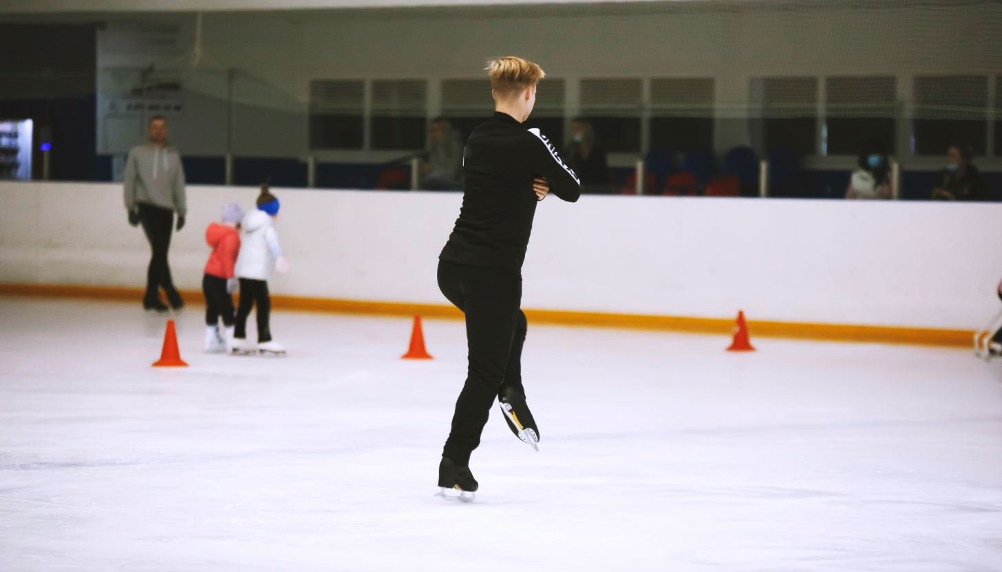 a figure skater performing figure skating jumps at a figure skating competition